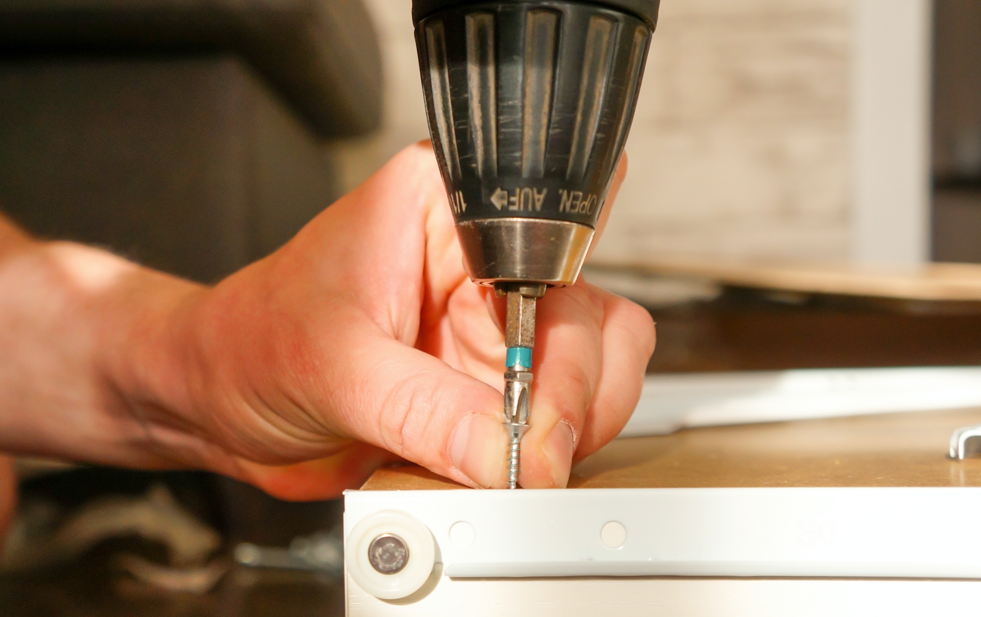 shutterstock_1715861089_1 repairing an office desk with a drill